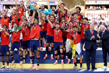 Rodri lifts the World Cup Trophy alongside Donald Trump and Gianni Infantino.