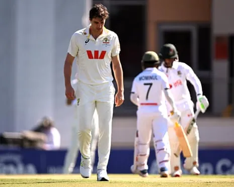 Australia captain Pat Cummins walks back to his mark as Bangladesh’s Tanzid Hasan and Mominul Haque pile on the pain on day two of the first Test in Darwin
